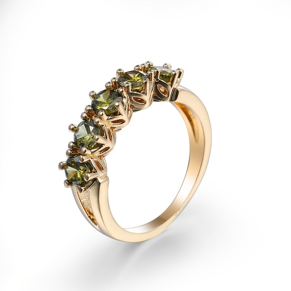 Gouden ring met vijf groene edelstenen
