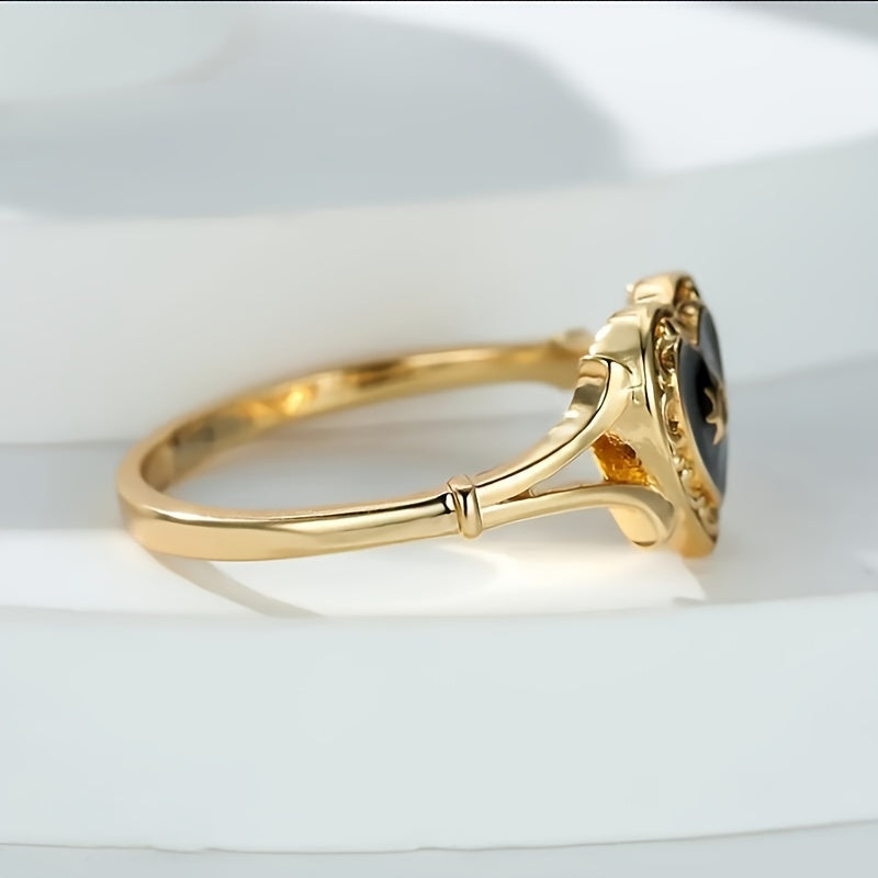 Gouden ring met zwart geëmailleerd hart en zonnetje