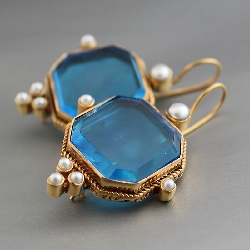 Gouden vintage oorbellen met blauwe glassteen en parels