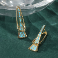 Gouden oorbellen met turquoise en gekruist design