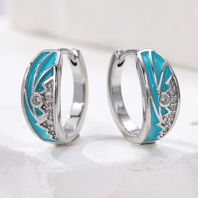 Zilveren oorbellen met turquoise emaille zonsopgangmotief
