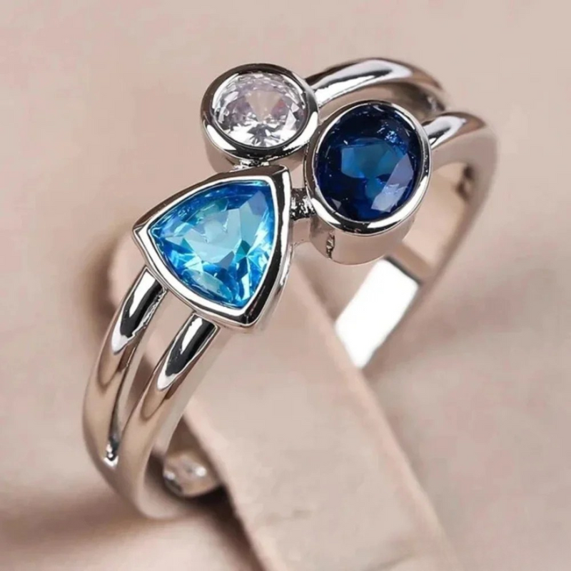 Zilveren ring met blauwe topaas en saffier