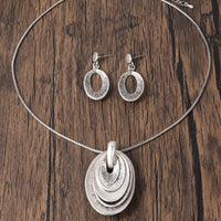 Zilveren ketting- en oorbellenset met gelaagde ovale hanger