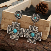 Zilveren etnische oorbellen met turquoise kruismotief