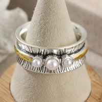 Zilveren ring met parels en goudkleurige spinner band
