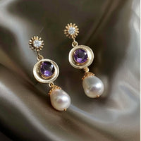 Gouden vintage oorbellen met paarse steen en parel