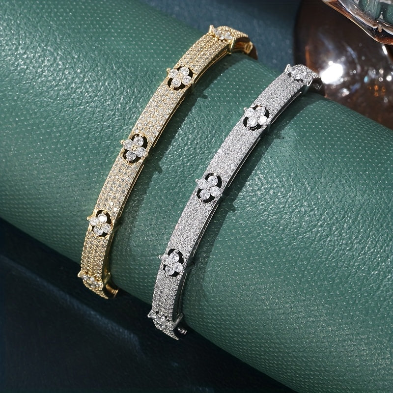 Gouden bangle armband met bloemen en zirkonia