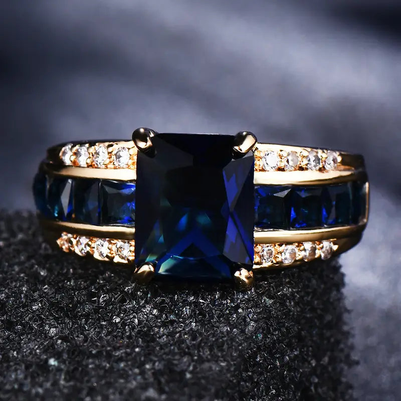 Gouden ring met blauwe steen en zijstenen
