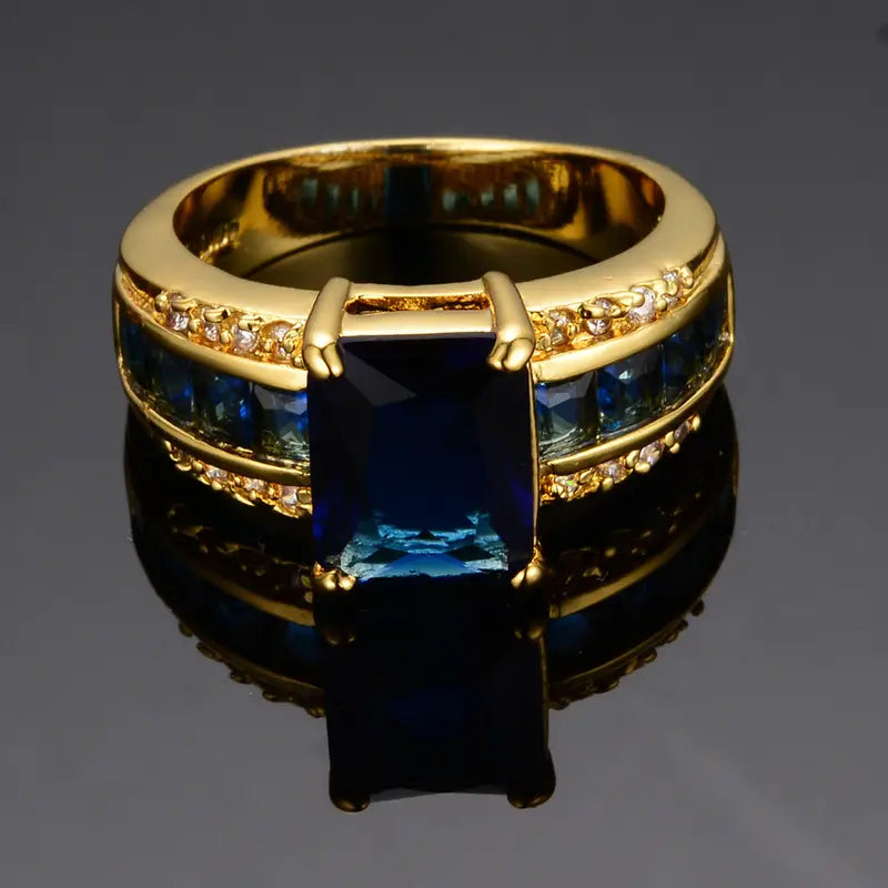 Gouden ring met blauwe steen en zijstenen