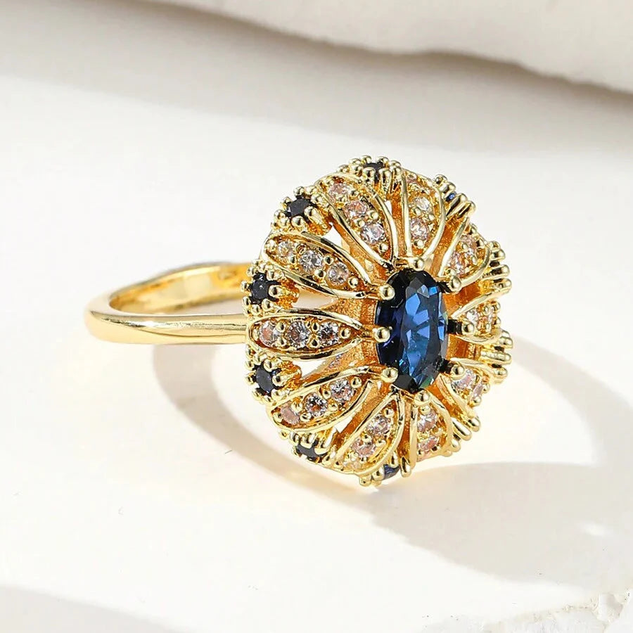 Gouden vintage ring met blauwe ovale steen en zirkonia