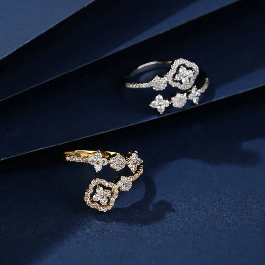 Gouden open wikkelring met zirkonia bloemen
