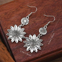 Zilveren bohemian oorbellen met zonnebloem