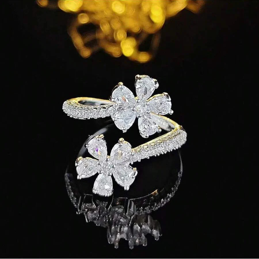 Gouden open ring met twee zirkonia bloemen