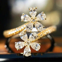 Gouden open ring met twee zirkonia bloemen