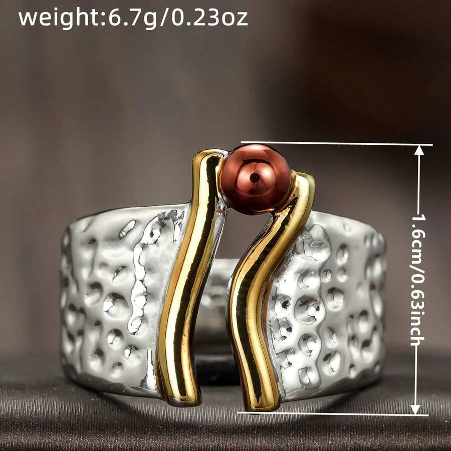 Zilveren ring met goudaccent en koperkleurige kraal