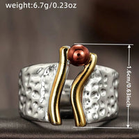 Zilveren ring met goudaccent en koperkleurige kraal