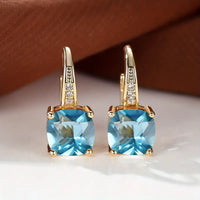 Gouden oorbellen met blauwe kussensteen