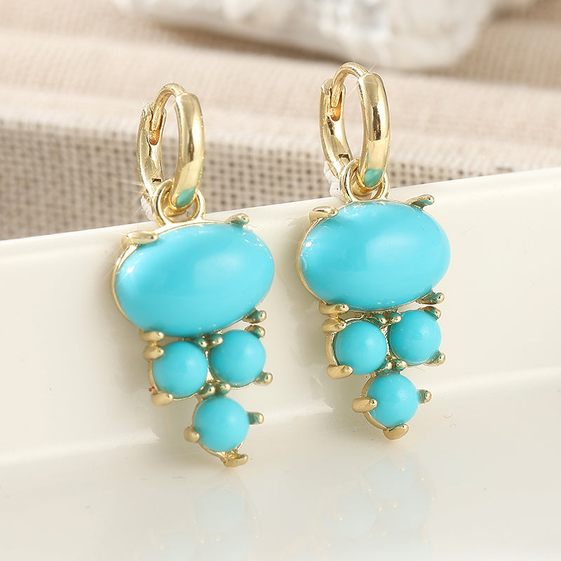 Gouden oorbellen met ovale turquoise en kraaltjes