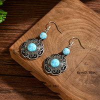 Zilveren boho hartoorbellen met vlinder en turquoise