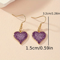 Paarse glitter oorbellen met hart