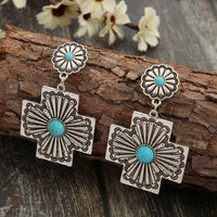 Zilveren etnische oorbellen met turquoise kruismotief
