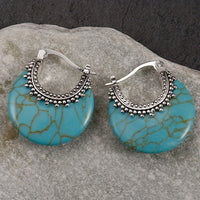 Zilveren bohemian oorbellen met turquoise schijf