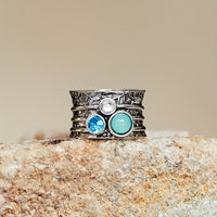 Zilveren spinner ring met blauwe edelstenen