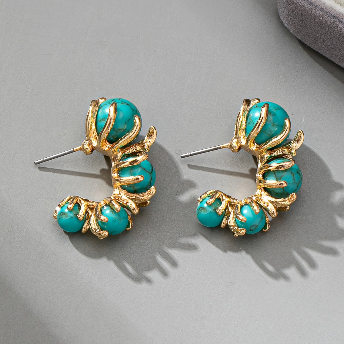 Gouden oorbellen met turquoise kralen