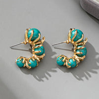Gouden oorbellen met turquoise kralen