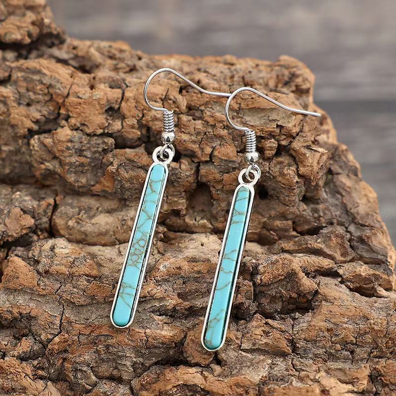 Zilveren oorbellen met langwerpige turquoise staaf
