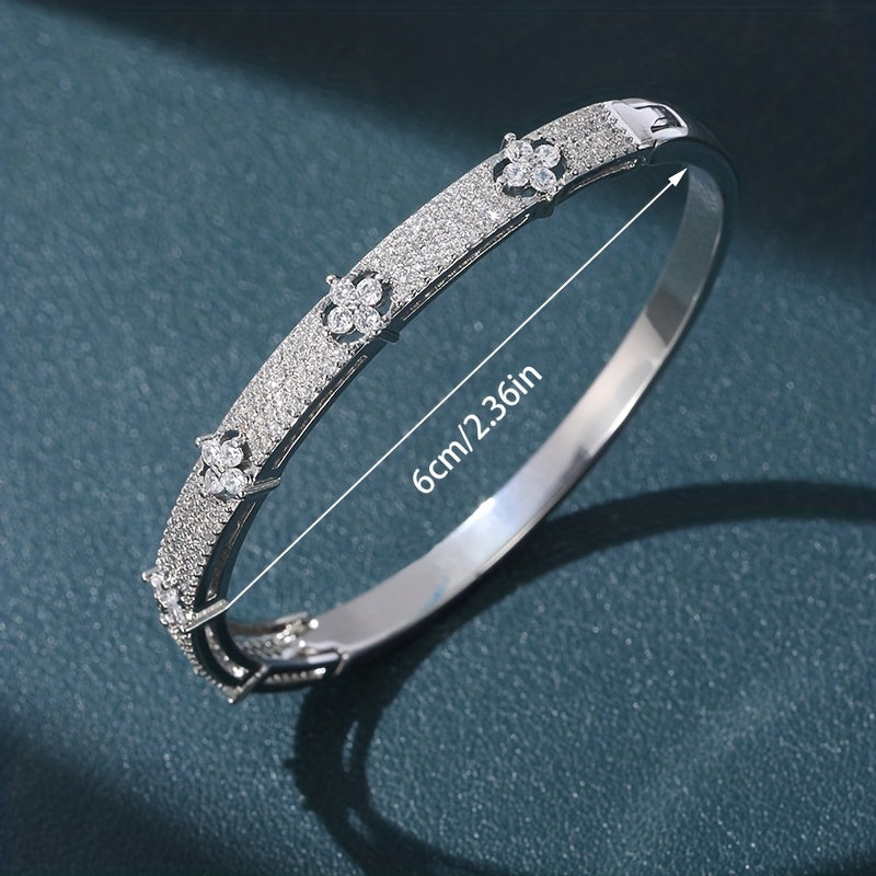 Gouden bangle armband met bloemen en zirkonia