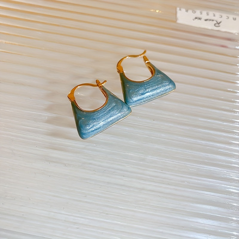 Gouden oorbellen met parelmoer handtasje
