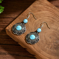 Zilveren boho hartoorbellen met vlinder en turquoise