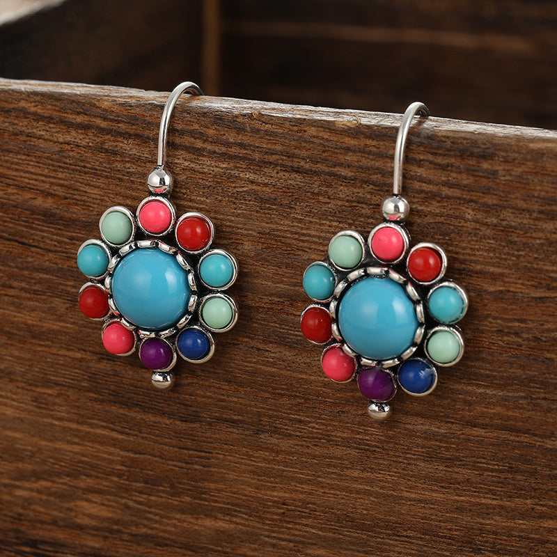Zilveren oorbellen met turquoise bloemmotief