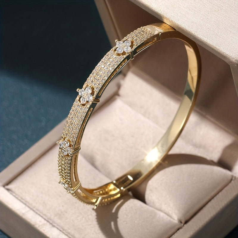 Gouden bangle armband met bloemen en zirkonia