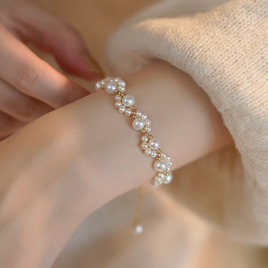 Gouden armband met parelclusters en hangbedeltje