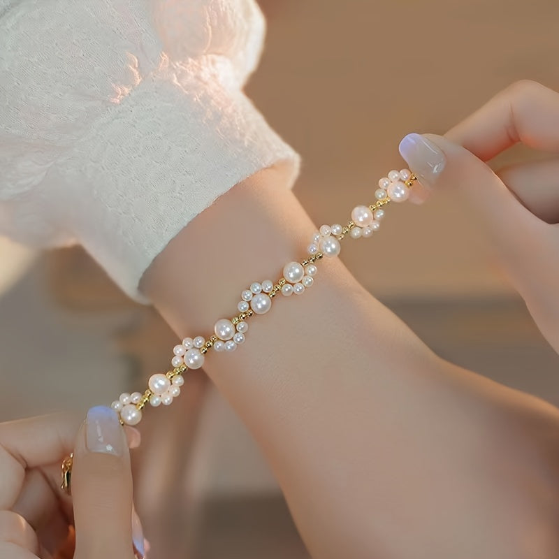 Gouden armband met parelclusters en hangbedeltje