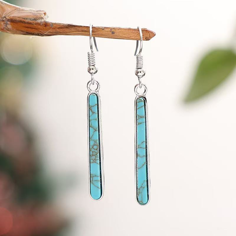 Zilveren oorbellen met langwerpige turquoise staaf