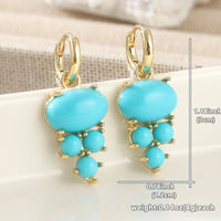 Gouden oorbellen met ovale turquoise en kraaltjes