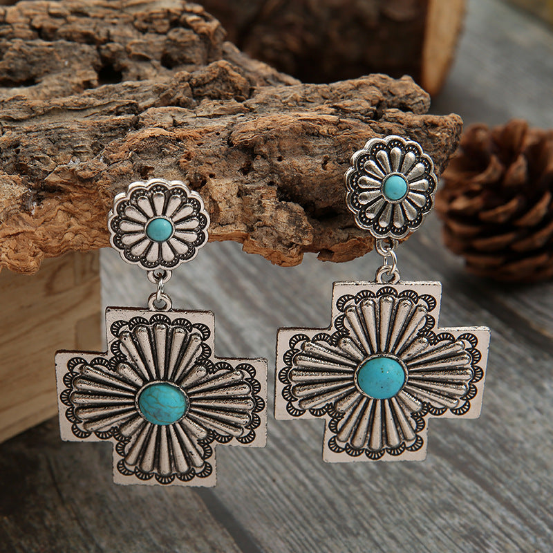 Zilveren etnische oorbellen met turquoise kruismotief