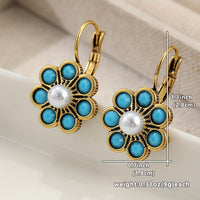 Gouden oorbellen met turkooizen bloem en parel
