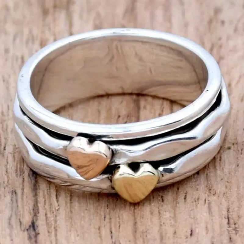Zilveren brede ring met roségouden en gouden hartjes