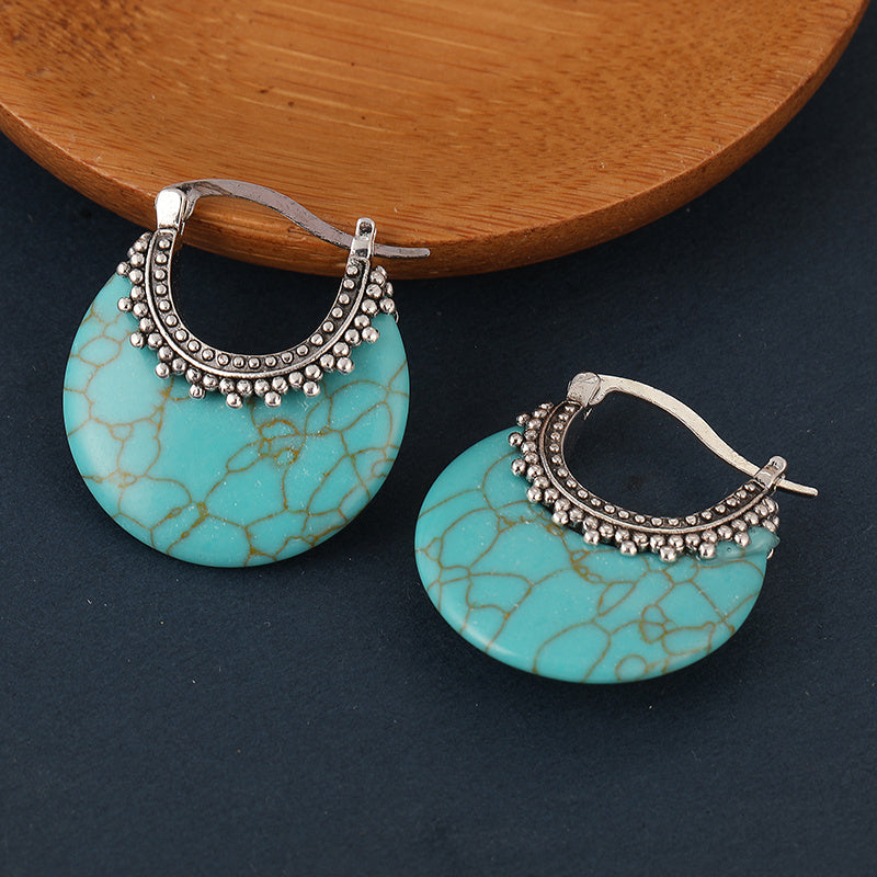 Zilveren bohemian oorbellen met turquoise schijf