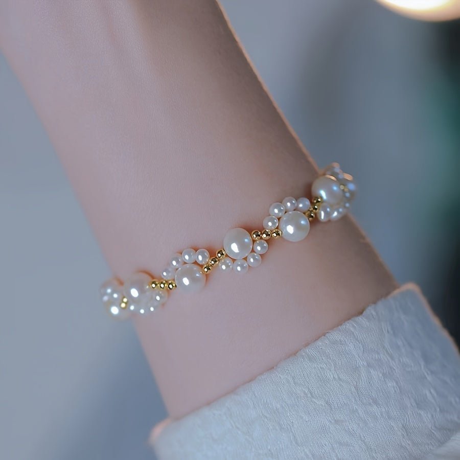 Gouden armband met parelclusters en hangbedeltje