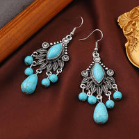 Zilveren bohemian oorbellen met turquoise kralen en bedels
