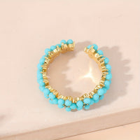 Gouden ring met turquoise kralen bloemmotief