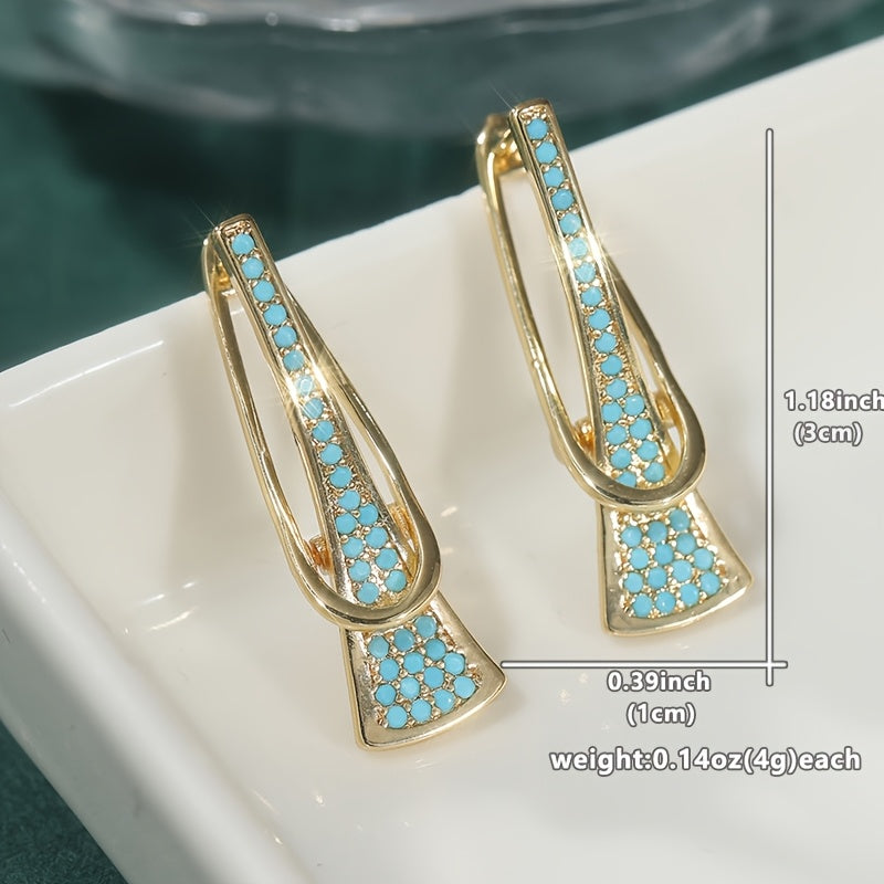 Gouden oorbellen met turquoise en gekruist design