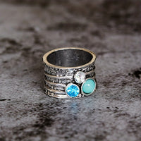 Zilveren spinner ring met blauwe edelstenen