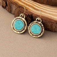 Goudkleurige vintage oorbellen met ronde turquoise