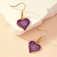 Paarse glitter oorbellen met hart